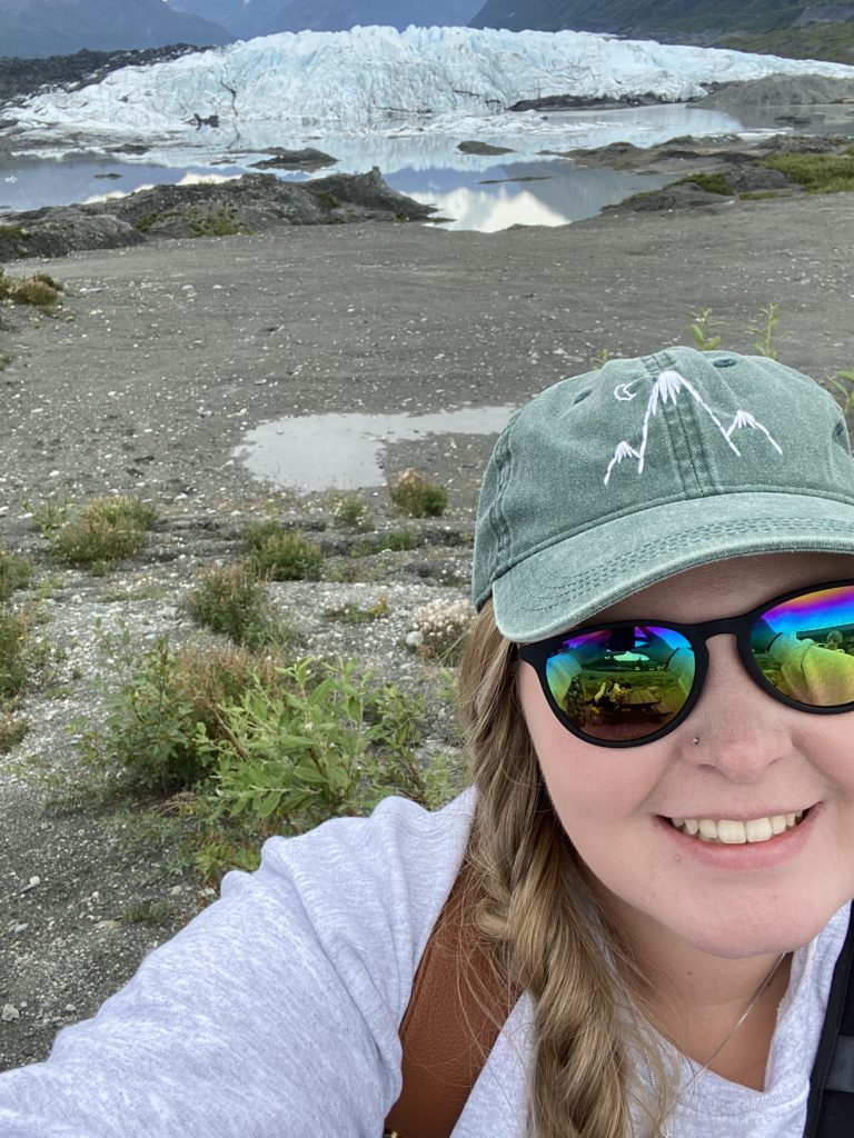 selfie of me standing in front of the huge glacier 