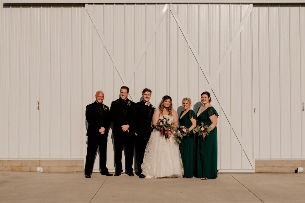 Bride and groom with their best men and their maid of honors. All smiling at the camera. 